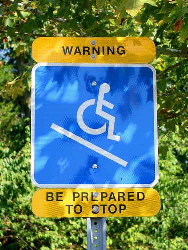 Wheelchair incline warning sign. Warning be prepared to stop!